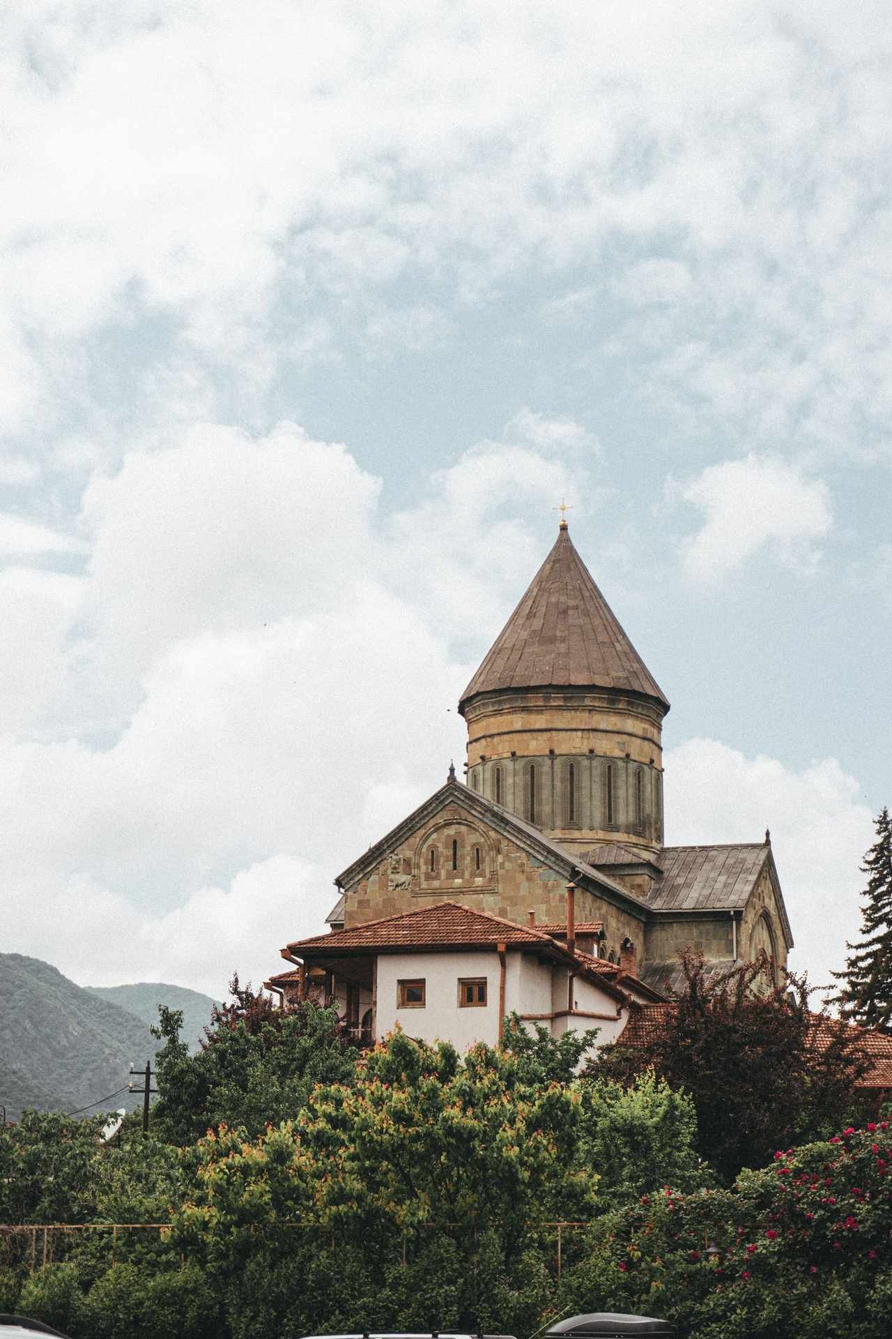Svetitskhoveli Cathedral, a large stone cathedral with a central dome, in the old town of Mtskheta, Georgia