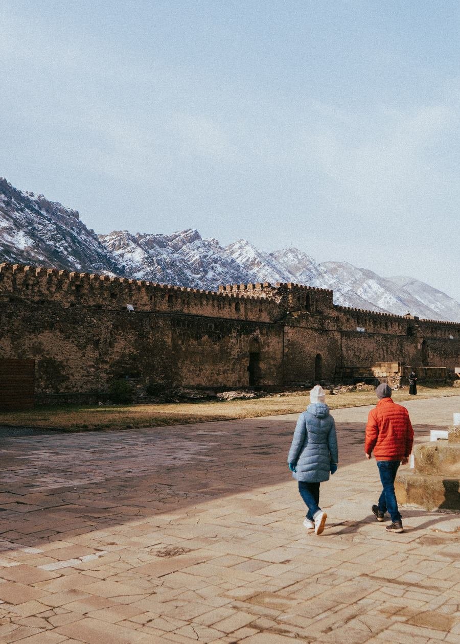 The defensive wall around Svetitskhoveli Cathedral with mountains behind