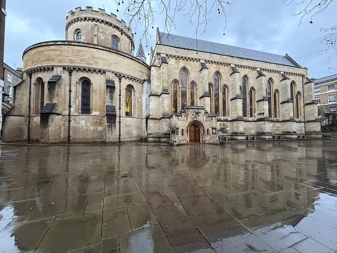 Temple Church, its Round and chancel, seen across a rain-washed courtyard of the Inns of Court