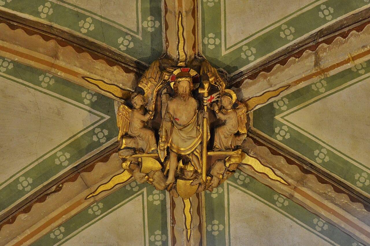 A gilded roof boss of the Resurrection in the nave vault of Tewkesbury Abbey