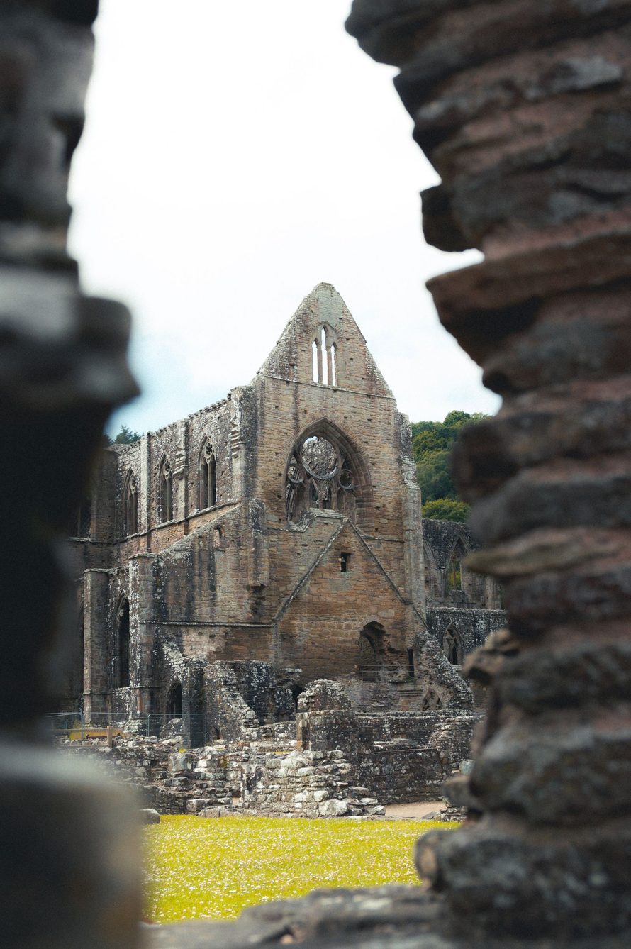 The ruined church of Tintern Abbey framed by a broken stone archway