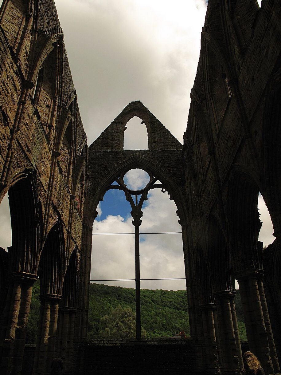The empty frame of the great east window of Tintern Abbey, with a single slender mullion rising through it