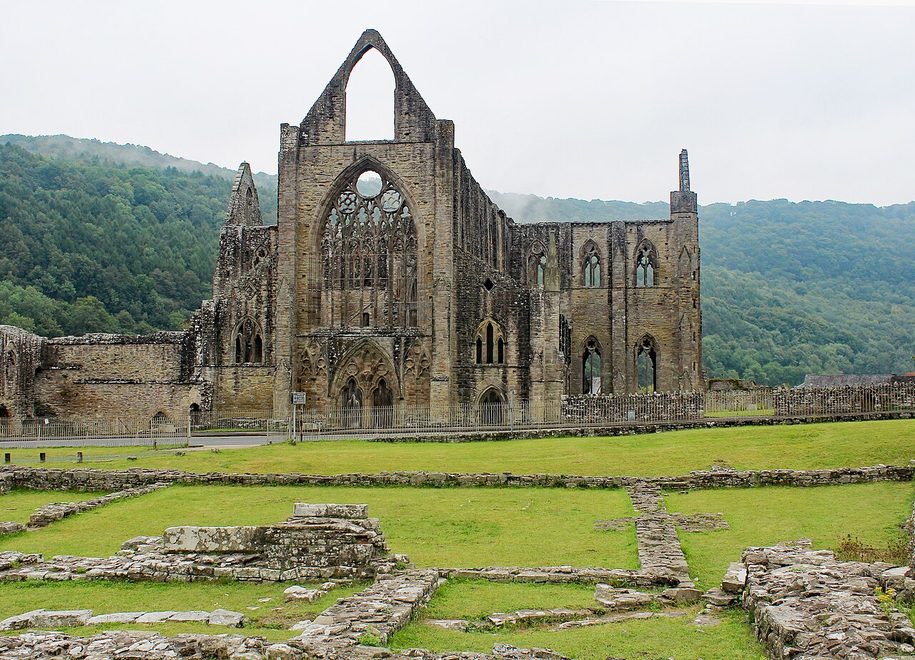 The west front of Tintern Abbey with its tall seven-light window and the doorway below
