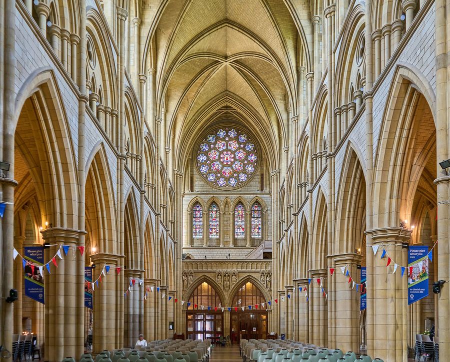 The tall vaulted nave of Truro Cathedral looking west towards the great west window