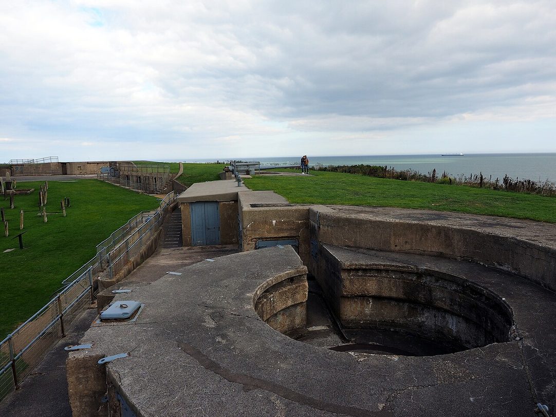 A circular concrete gun emplacement on the clifftop at Tynemouth Castle, looking out to sea