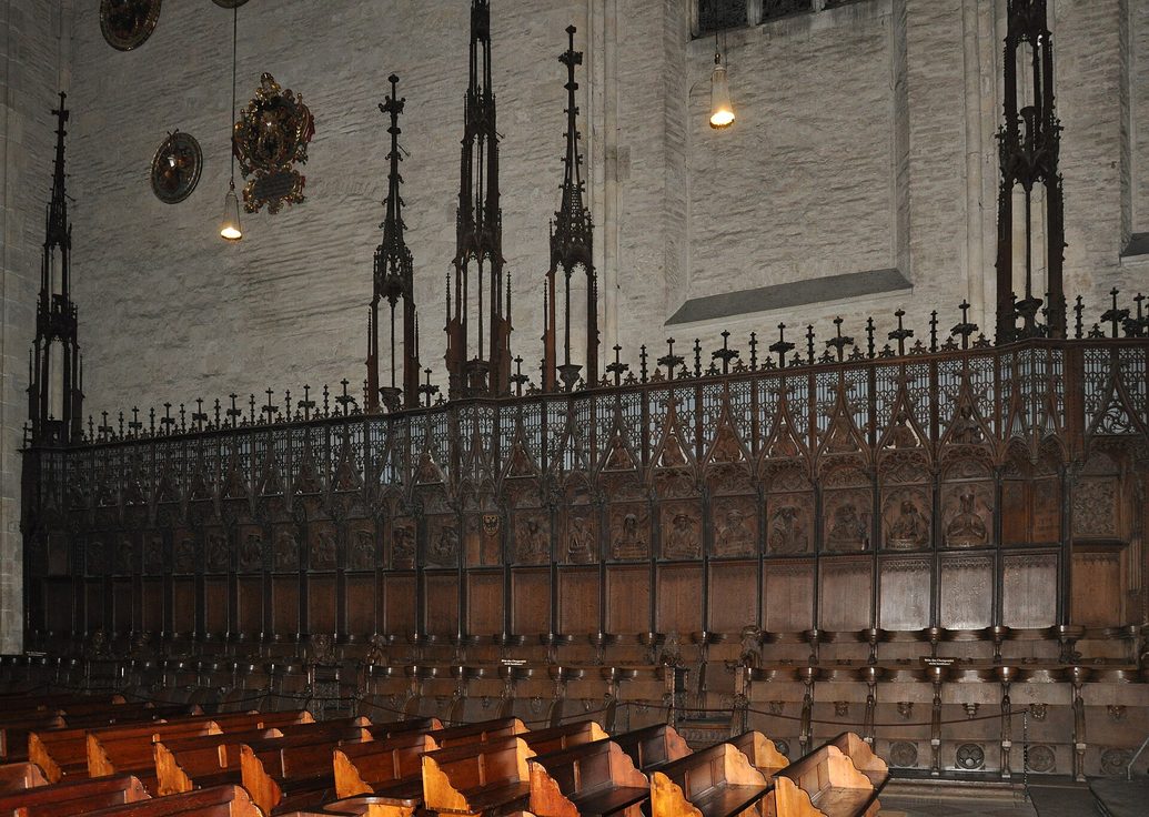 The carved oak choir stalls of Ulm Minster with busts of sibyls and philosophers along the top