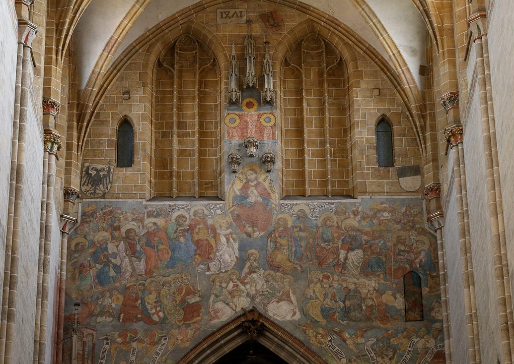 The large painted Last Judgement over the chancel arch of Ulm Minster, with Christ enthroned above the dead rising from their graves