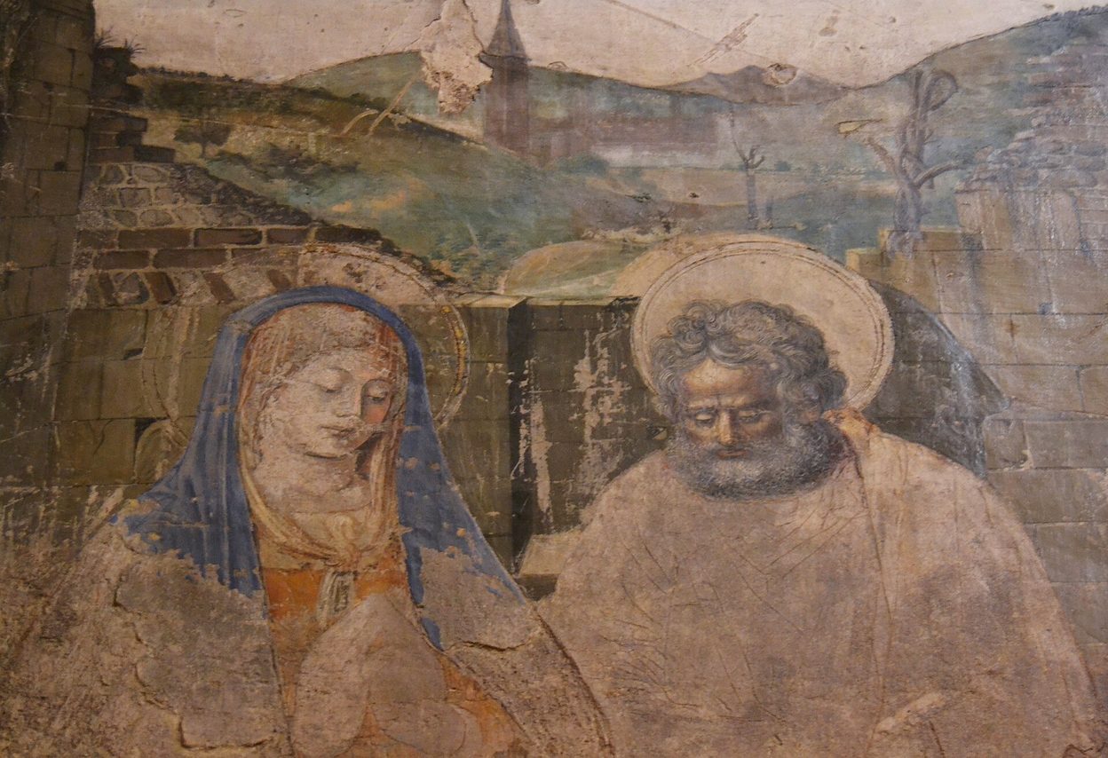 Detail of a Renaissance wall painting in Valencia Cathedral showing the faces of the Virgin Mary and St Joseph against a landscape