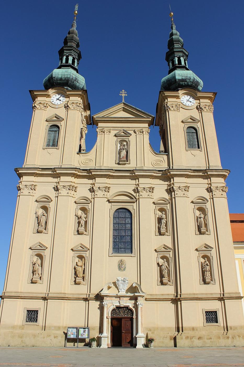 The pale Baroque west front of the Velehrad basilica with two onion-domed towers