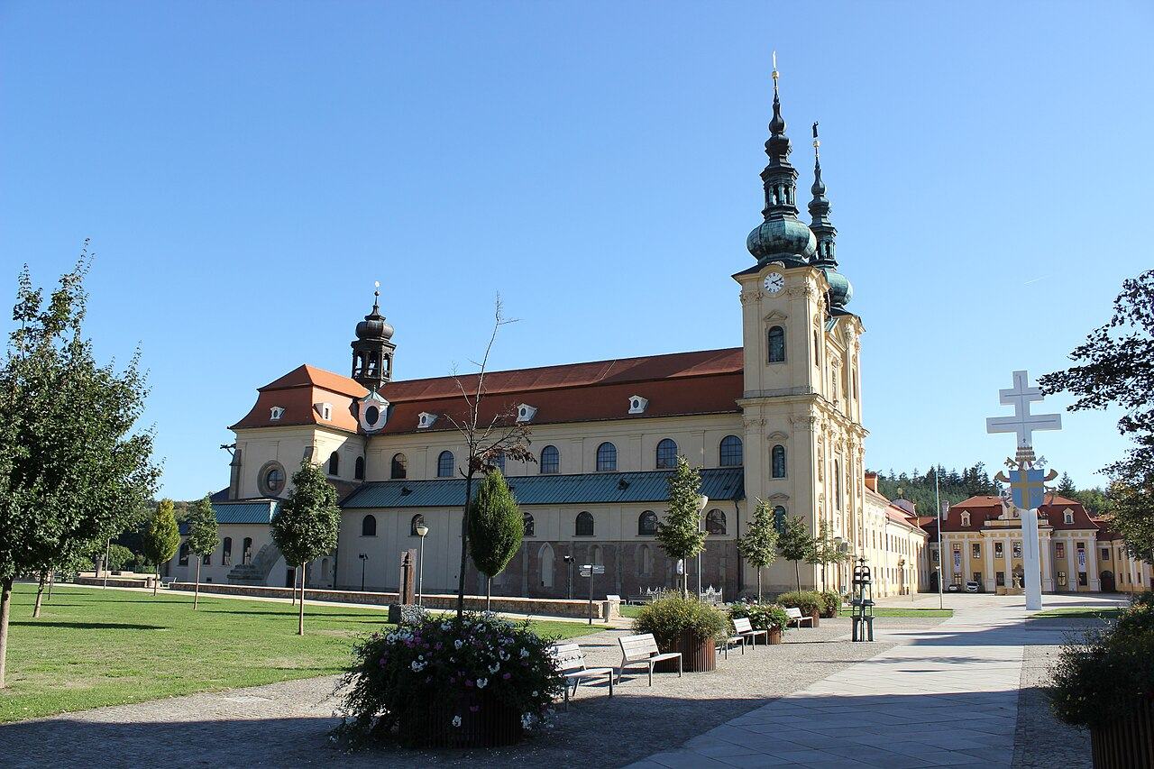 The Baroque basilica of Velehrad with its two towers and the long former monastery beside it, with a double cross in front