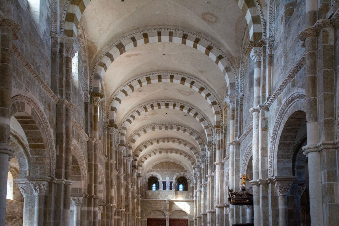 The Romanesque nave of Vézelay with round arches banded in alternating light and dark stone