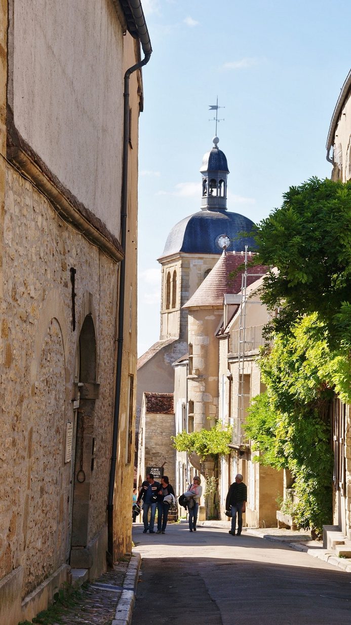 The steep main street of Vézelay village, lined with old stone houses, leading up the hill