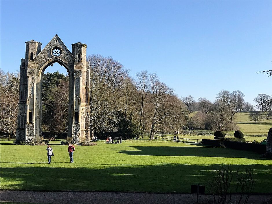 The ruined east window arch of Walsingham Priory standing alone in parkland