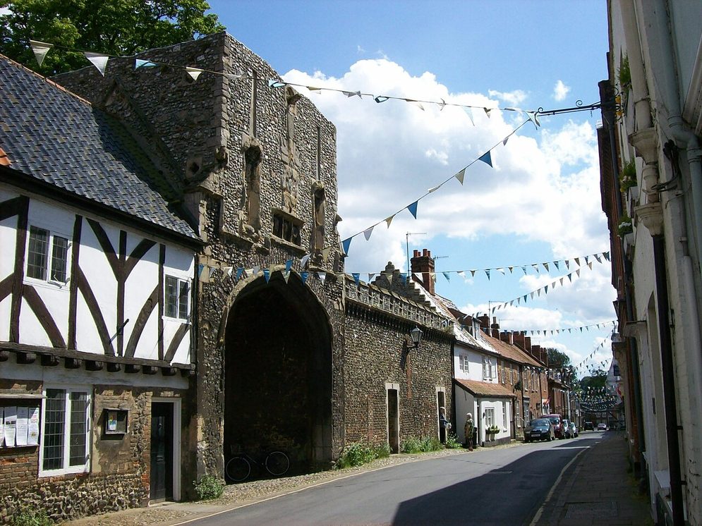 The High Street of Little Walsingham, with timber-framed and flint houses and the priory gatehouse