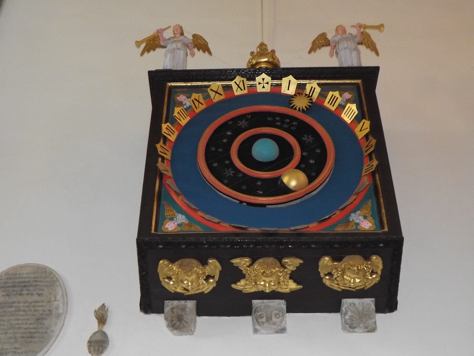 The astronomical clock at Wimborne Minster with the earth at the centre and the sun and moon circling it