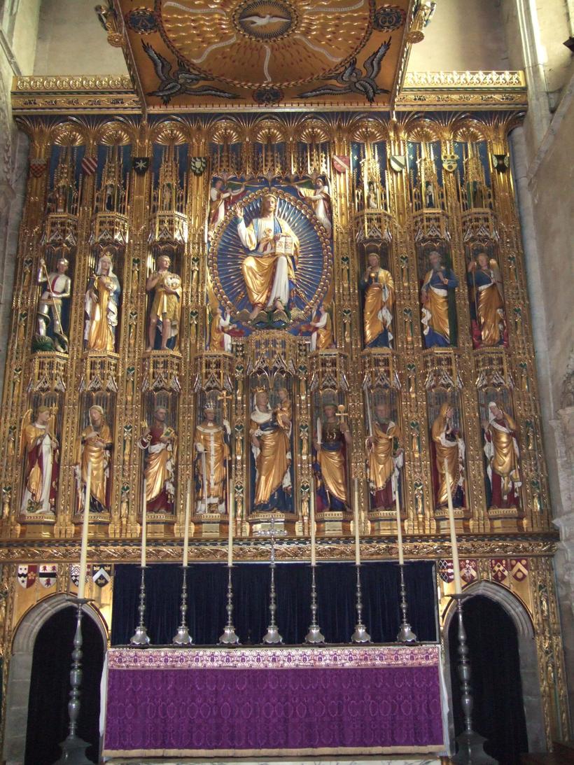 The gold reredos by Sir Ninian Comper at Wymondham Abbey, with tiers of painted and gilded figures under a canopy