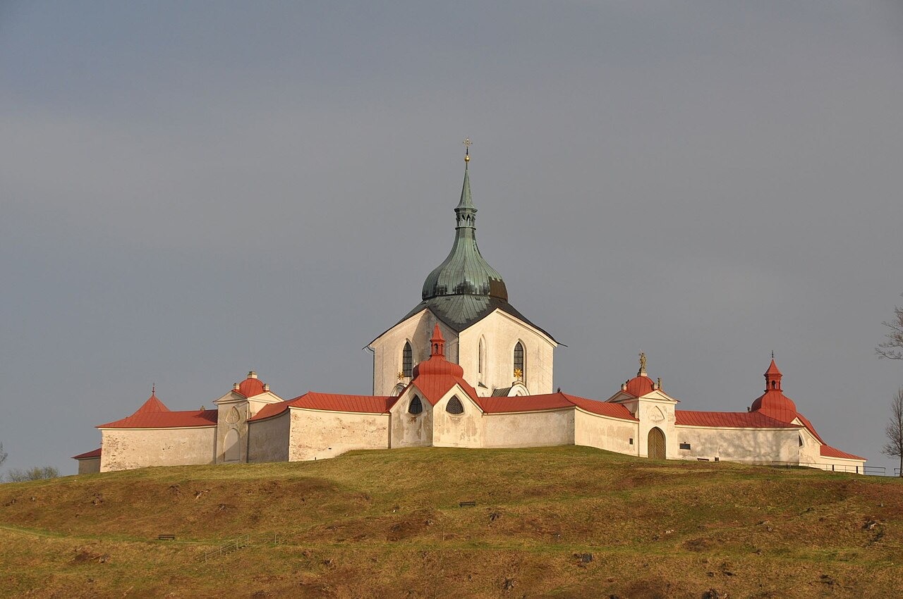 The Zelená Hora church and cloister on a bare hilltop under a grey sky