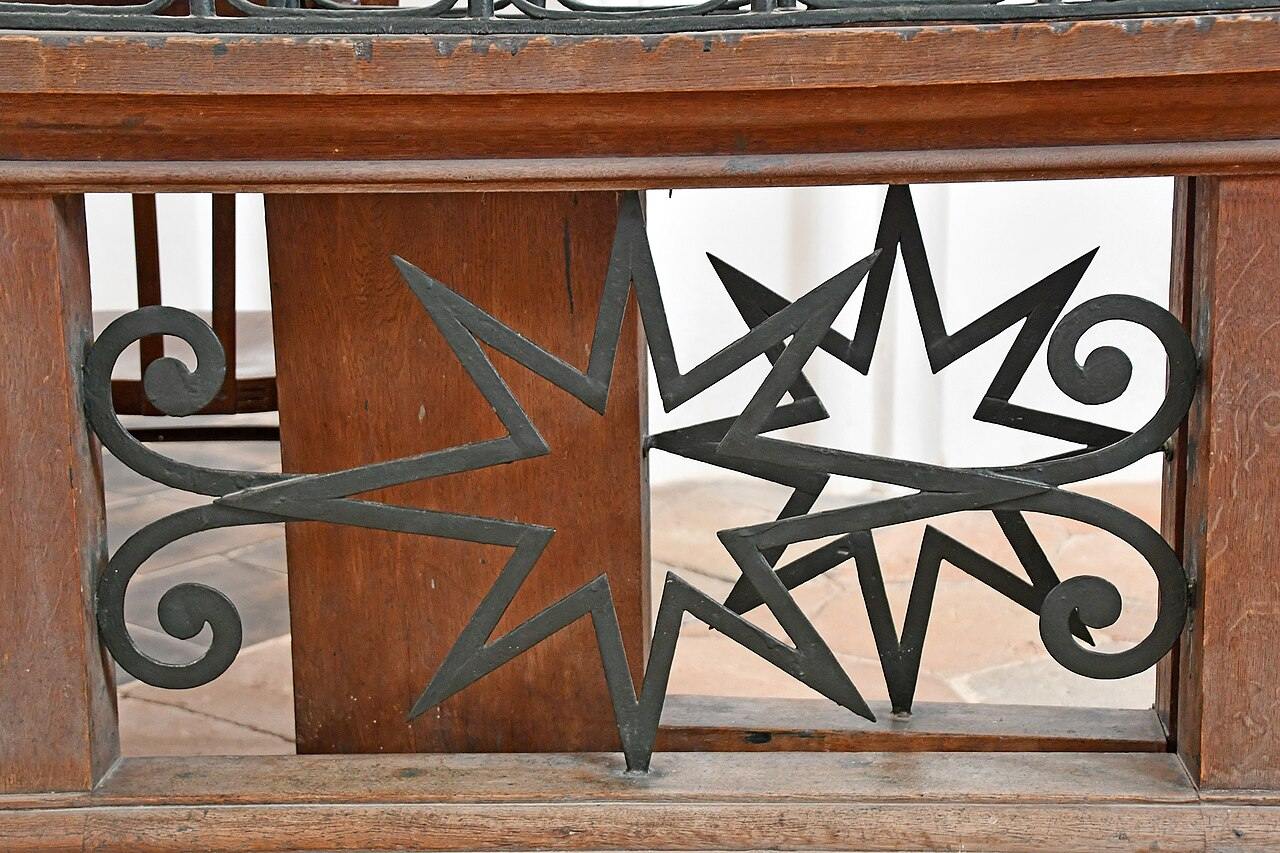 An iron railing of the gallery made of interlocking stars in Zelená Hora church